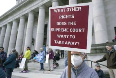 FILE - A person holds a sign referencing the U.S. Supreme Court as they take part in a rally in favor of abortion rights on the steps of the Temple of Justice, which houses the Washington state Supreme Court, Tuesday, May 3, 2022, at the Capitol in Olympia, Wash. (AP Photo/Ted S. Warren, File)