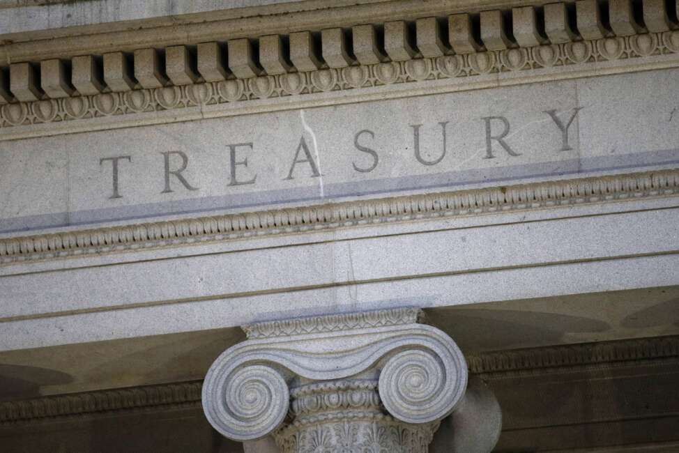 FILE - This June 6, 2019, photo shows the U.S. Treasury Department building at dusk in Washington. The U.S. announced Friday, May 6, 2022, that it is sanctioning North Korean digital currency mixing firm Blender.io, which the country allegedly uses to launder stolen virtual currency and support cyber crimes. (AP Photo/Patrick Semansky, File)