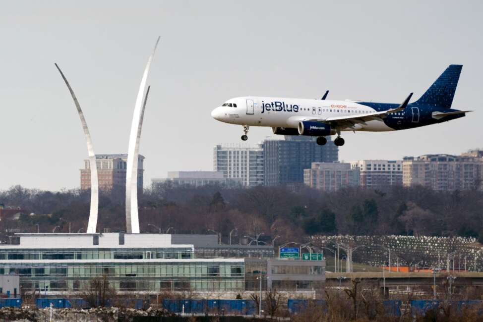 FILE - A JetBlue passenger flight lands at Reagan Washington National Airport in Arlington, Va., across the Potomac River from Washington, Wed., Jan. 19, 2022. On Friday, June 17, 2022, federal regulators said Verizon and AT&amp;T will delay part of their 5G rollout near airports to give airlines more time to ensure that equipment on their planes is safe from interference from the wireless signals, but the airline industry is not happy about the deal. (AP Photo/J. Scott Applewhite, File)