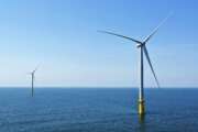 FILE - Two of the offshore wind turbines which have been constructed off the coast of Virginia Beach, Va. are seen on June 29, 2020. The White House is launching a formal partnership with 12 East Coast governors to boost the growing offshore wind industry. It's a key element of President Joe Biden's plan for climate change. (AP Photo/Steve Helber, File)