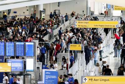 People wait in a TSA line at the John F. Kennedy International Airport on Tuesday, June 28, 2022, in New York. (AP Photo/Julia Nikhinson)