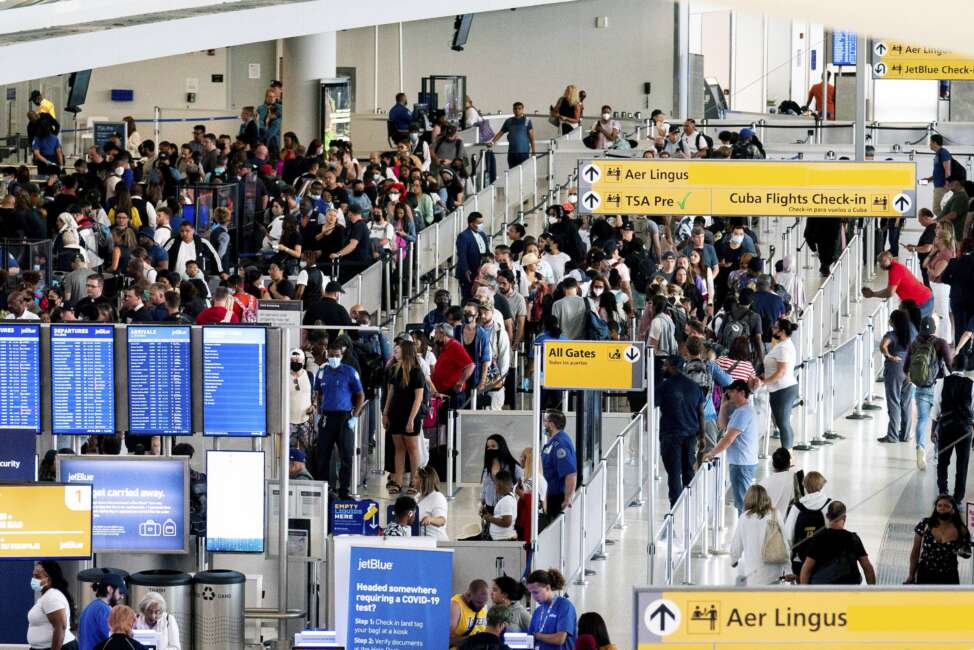 People wait in a TSA line at the John F. Kennedy International Airport on Tuesday, June 28, 2022, in New York. (AP Photo/Julia Nikhinson)