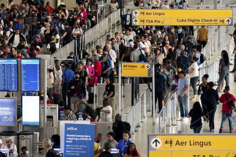 People wait in a TSA line at the John F. Kennedy International Airport on Tuesday, June 28, 2022, in New York. (AP Photo/Julia Nikhinson)