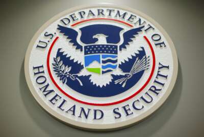 FILE - The Department of Homeland Security logo is seen during a news conference in Washington, Feb. 25, 2015. DHS says a looming Supreme Court decision on abortion, an increase of migrants at the U.S.-Mexico border and the midterm elections are potential triggers for extremist violence over the next six months. DHS said June 7, 2022, in the National Terrorism Advisory System bulletin the U.S. was in a 