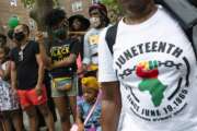 FILE - People attend Juneteenth celebrations in the Harlem neighborhood of New York, on June 19, 2021. Recognition of Juneteenth, the effective end of slavery in the U.S., gained traction after the police killing of George Floyd in 2020. But after an initial burst of action, the movement to have it recognized as an official holiday in the states has largely stalled. (AP Photo/Eduardo Munoz Alvarez, File)