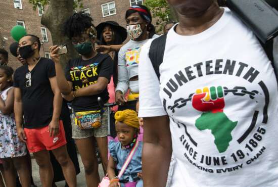 FILE - People attend Juneteenth celebrations in the Harlem neighborhood of New York, on June 19, 2021. Recognition of Juneteenth, the effective end of slavery in the U.S., gained traction after the police killing of George Floyd in 2020. But after an initial burst of action, the movement to have it recognized as an official holiday in the states has largely stalled. (AP Photo/Eduardo Munoz Alvarez, File)