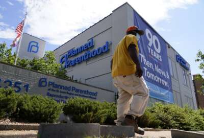 A person walks past Planned Parenthood Friday, June 24, 2022, in St. Louis. Most abortions are now illegal in Missouri following a U.S. Supreme Court decision that ended a constitutional protection for abortion. (AP Photo/Jeff Roberson)