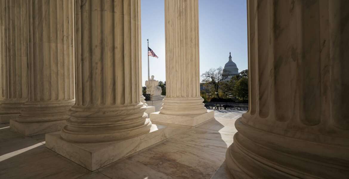 FILE - The Supreme Court is seen in Washington, with the U.S. Capitol in the distance, Nov. 4, 2020. The end of Roe v. Wade started in the Senate. The Senate Republican partnership with President Donald Trump to confirm conservative justices paved the way for the Supreme Court’s landmark ruling on abortion rights. (AP Photo/J. Scott Applewhite, File)