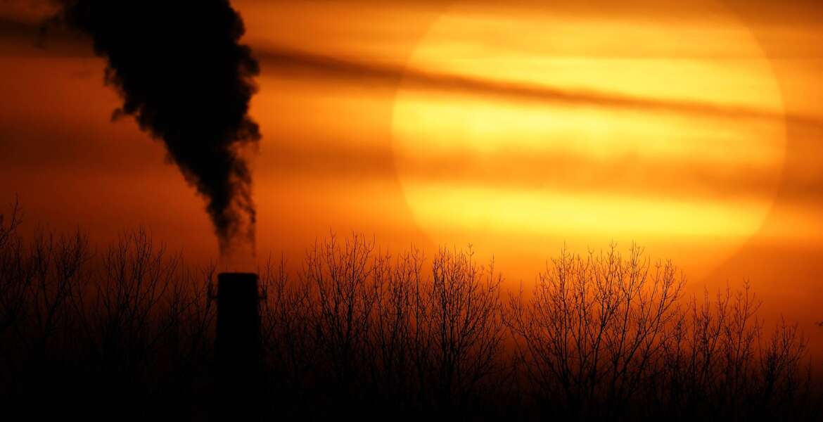 FILE - Emissions from a coal-fired power plant are silhouetted against the setting sun in Kansas City, Mo., Feb. 1, 2021. The Supreme Court on Thursday, June 30, 2022, limited how the nation’s main anti-air pollution law can be used to reduce carbon dioxide emissions from power plants. By a 6-3 vote, with conservatives in the majority, the court said that the Clean Air Act does not give the Environmental Protection Agency broad authority to regulate greenhouse gas emissions from power plants that contribute to global warming. (AP Photo/Charlie Riedel, File)
