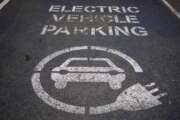 A sign of electric car charging space is seen at a beachside car park in Sydney, Australia, Tuesday, July 26, 2022. Australia's Parliament has sat for the first time since May elections with new Prime Minister, Anthony Albanese determined to have a greenhouse gas reduction target enshrined in law. Legislation that would force Australia to reduce its emissions by 43% below 2005 levels by the end of the decade will be introduced Wednesday into the House of Representatives.(AP Photo/Mark Baker)