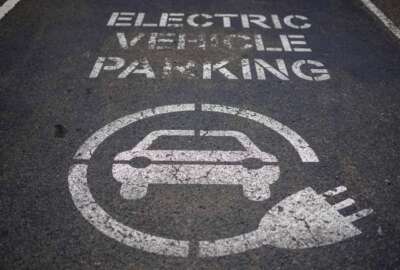 A sign of electric car charging space is seen at a beachside car park in Sydney, Australia, Tuesday, July 26, 2022. Australia's Parliament has sat for the first time since May elections with new Prime Minister, Anthony Albanese determined to have a greenhouse gas reduction target enshrined in law. Legislation that would force Australia to reduce its emissions by 43% below 2005 levels by the end of the decade will be introduced Wednesday into the House of Representatives.(AP Photo/Mark Baker)