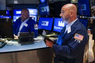 Traders work on the floor at the New York Stock Exchange in New York, Wednesday, July 27, 2022. (AP Photo/Seth Wenig)