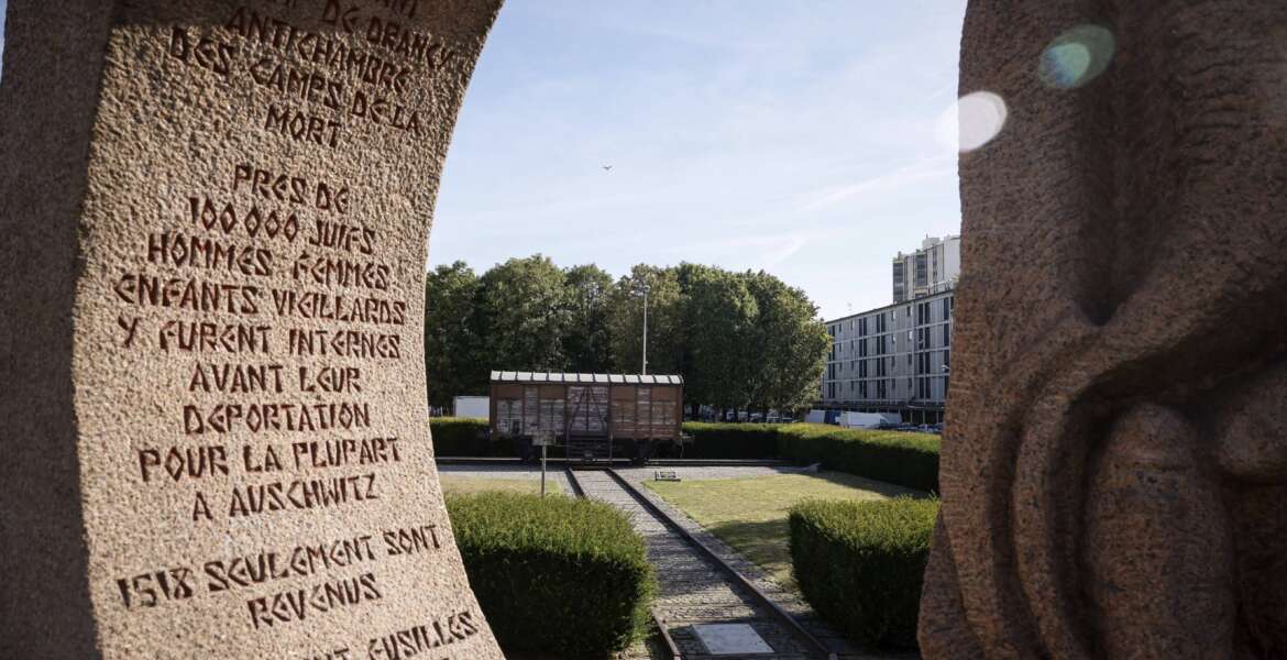 A memorial is pictured near a train car symbolizing the Drancy camp, at the Shoah memorial Tuesday, July 12, 2022 in Drancy, outside Paris. The Paris mayor and head of the French Holocaust Memorial will mark the 80th anniversary of the round-up of the Vel d'Hiv, the biggest Nazi roundup of Jews in France, visiting the site used as an internment camp during World War II for tens of thousands of people who were then sent on to Auschwitz and other death camps. (AP Photo/Thomas Padilla)