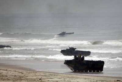 FILE - Amphibious Assault Vehicles storm Red Beach during exercises at Camp Pendleton, Calif., June 2, 2010. The U.S. Marine Corps will keep its new amphibious combat vehicle - a kind of seafaring tank - out of the water while it investigates why two of the vehicles ran into troubles off the Southern California coast this week amid high surf, military officials said Wednesday, July 20, 2022. (AP Photo/Lenny Ignelzi, File)