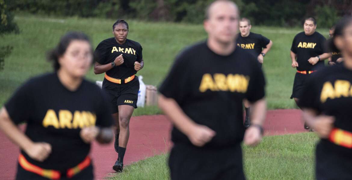 Students in the new Army prep course run around a track during physical training exercises at Fort Jackson in Columbia, S.C., Saturday, Aug. 27, 2022. The new program prepares recruits for the demands of basic training. (AP Photo/Sean Rayford)