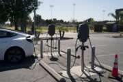 Electric vehicle chargers are seen in the parking lot of South El Monte High School in South El Monte, Calif., Friday, Aug. 26, 2022. Discounted prices, car-share programs, and a robust network of public charging stations are among the ways California will try to make electric vehicles affordable and convenient for people of all income levels as it phases out the sale of new gas cars by 2035. Advocates for the policy say the switch from gas- to battery-powered cars is a necessary step to reducing pollution in disadvantaged neighborhoods, but that the state make sure those residents can access the cars, too.(AP Photo/Jae C. Hong)