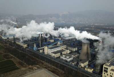 FILE - Smoke and steam rise from a coal processing plant in Hejin in central China's Shanxi Province on Nov. 28, 2019. China has cut off climate talks with the U.S. — imperiling future global climate negotiations, but not necessarily blunting the impacts of significant climate actions at home in both countries. (AP Photo/Sam McNeil, File)