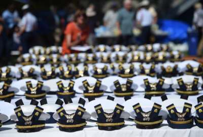 FILE - The new hats and shoulder bars for the graduates sit on a table before the start of the U.S. Coast Guard Academy's 141st Commencement Exercises Wednesday, May 18, 2022 in New London, Conn. The Coast Guard Academy is “disenrolling” seven cadets for failing to comply with the military's COVID-19 vaccination mandate, after their requests for religious exemptions were denied and they were ordered to leave campus.
The academy in New London, Connecticut, confirmed the disenrollments Tuesday, Aug. 30, 2022, The Day newspaper reported.  (AP Photo/Stephen Dunn, File)