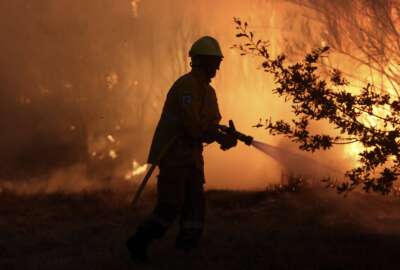 A firefighters works to stop a wildfire in Gouveia, in the Serra da Estrela mountain range, in Portugal on Thursday, Aug. 18, 2022. Authorities in Portugal said Thursday they had brought under control a wildfire that for almost two weeks raced through pine forests in the Serra da Estrela national park, but later in the day a new fire started and threatened Gouveia. (AP Photo/Joao Henriques)