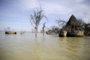 An old hotel is submerged by rising water levels in Lake Baringo in Kampi ya Samaki, Kenya on Wednesday, July 20, 2022. From drought to cyclones and sea level rise, the cost of damage caused by climate change in Africa will only get higher as the world warms, stirring concerns from activists and officials about how to pay for it.  (AP Photo/Brian Inganga)