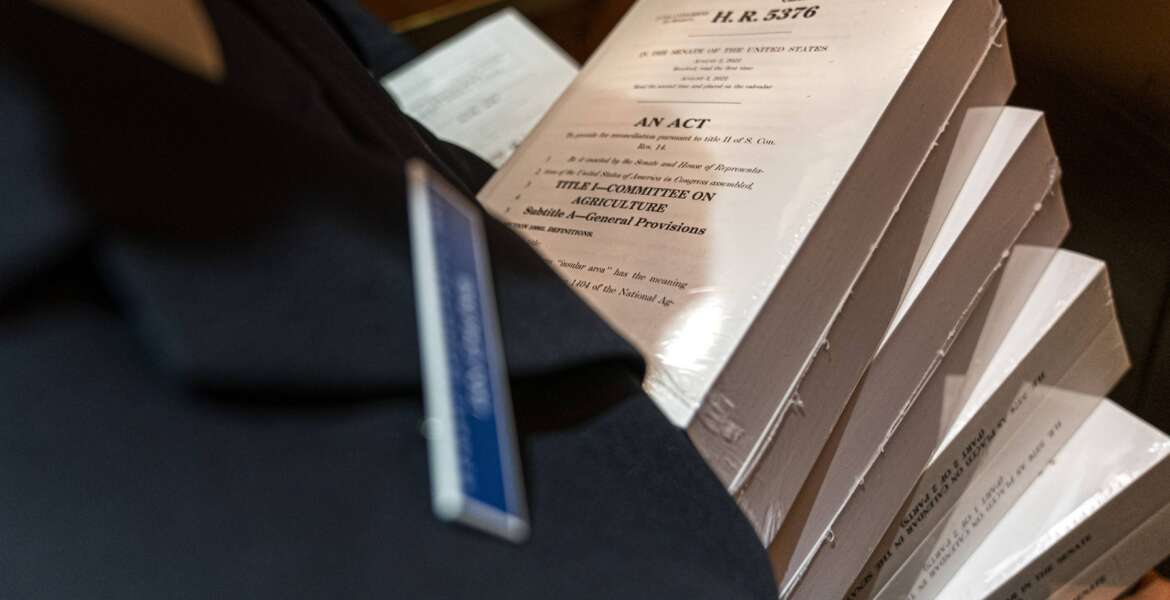 A page holds copies of the Inflation Reduction Act, inside an elevator inside the Capitol, Wednesday, Sept. 7, 2022, in Washington. (AP Photo/Jacquelyn Martin)