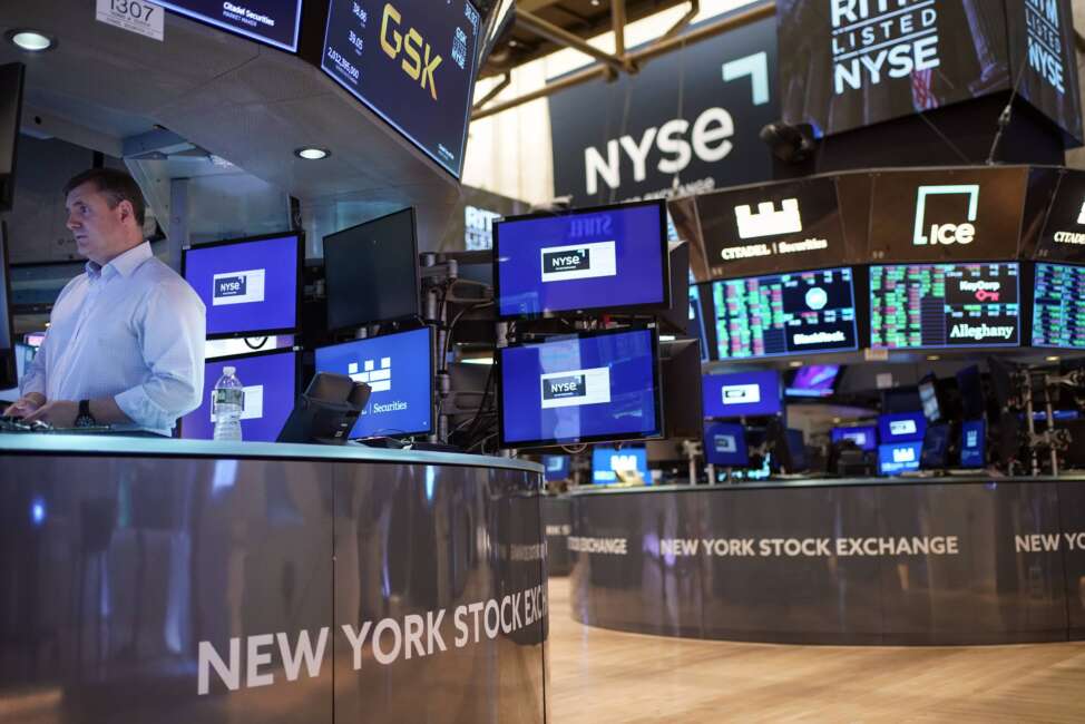 FILE - Traders work on the floor at the New York Stock Exchange in New York, Aug. 10, 2022. Stocks teetered between small gains and losses in morning trading on Wall Street Thursday, Sept. 15, 2022 which left major indexes well in the red for the week. (AP Photo/Seth Wenig, File)