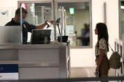 International passengers arrive at Miami international Airport where they are screened by U.S. Customs and Border Protection (CBP) using facial biometrics to automate manual document checks required for admission into the U.S. Friday, Nov. 20, 2020, in Miami. Miami International Airport is the latest airport to provide Simplified Arrival airport-wide. (AP Photo/Lynne Sladky)