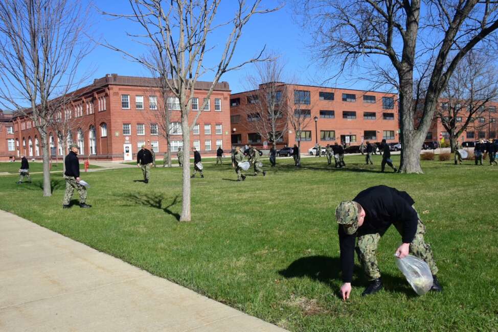 GREAT LAKES, Ill. (April 21, 2022) Sailors from Surface Combat Systems Training Command (SCSTC) Great Lakes perform base cleanup activities near the Boatswain's Mate "A" School trainer, Bldg. 122, on Naval Station Great Lakes' mainside. SCSTC GL is responsible for 24-hour supervision, leadership and professional development for over 10,000 Sailors annually across 22 courses of instruction in four school sites. (U.S. Navy photo by John Sheppard/Released)