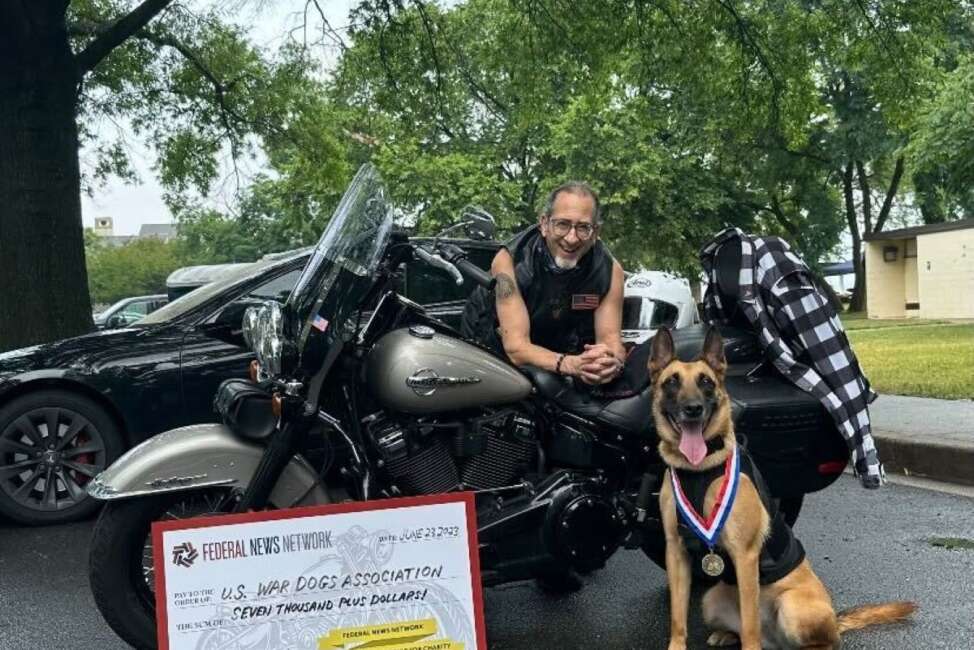 Tom Temin and retired War Dog Peggy share a moment.

Credit: Photo by Walter Dandridge