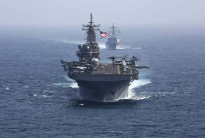 Amphibious assault ship USS Kearsarge and the Arleigh Burke-class guided-missile destroyer USS Bainbridge sail in formation.