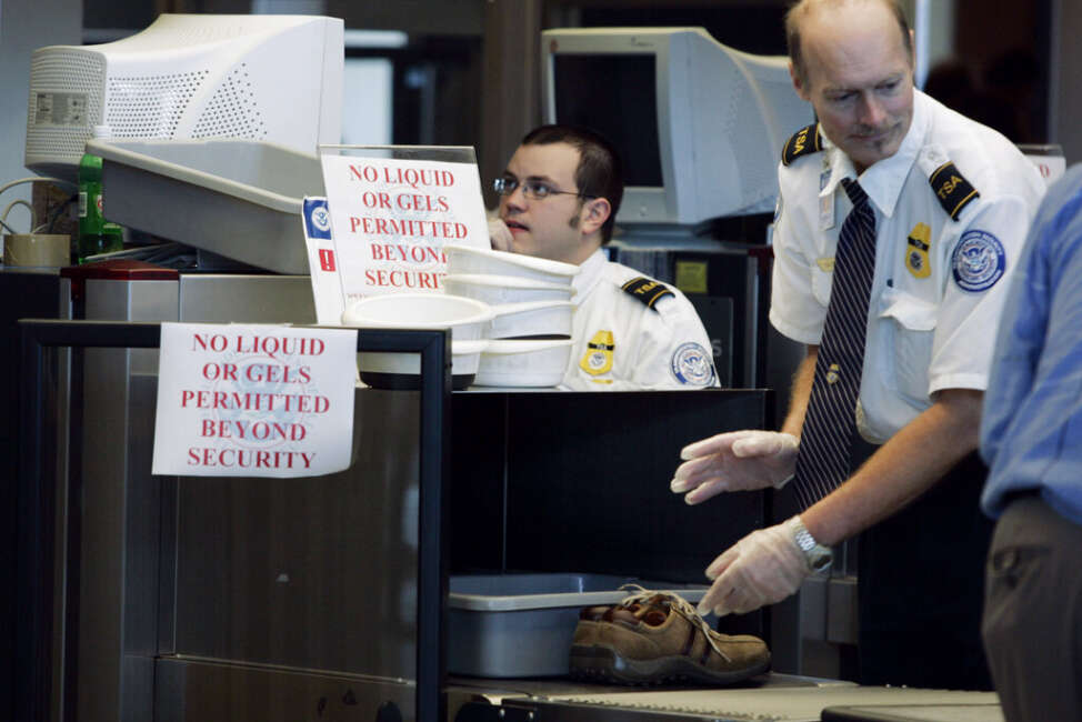 Transportation Security Administration (TSA) workers X-ray passengers belongings, including a pair of shoes, at Washington Dulles International Airport Friday, Aug. 11, 2006. The government's new order that all airline passengers put their shoes through X-ray machines won't help screeners find a liquid or gel that can be used as a bomb. The machines are unable to detect explosives, according to a Homeland Security report on aviation screening recently obtained by The Associated Press. (AP Photo/Charles Dharapak)