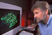 Research chemist Vincent Edwards examines a computer graphic image of an enzyme model used in the design of cotton-based chronic-wound dressings. (Photo by Peggy Greb, k10175-1 )