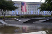 FILE — An American flag is unfurled at the Pentagon, in Washington, Sept. 11, 2021, at sunrise on the morning of the 20th anniversary of the terrorist attacks. Americans are looking back on the horror and legacy of 9/11, gathering Monday, Sept. 11, 2023, at memorials, firehouses, city halls and elsewhere to observe the 22nd anniversary of the deadliest terror attack on U.S. soil. (AP Photo/Alex Brandon)