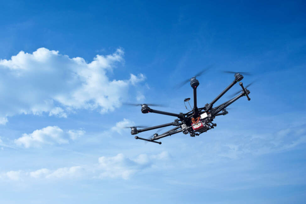 Copter flight against the blue sky. RC aerial drone.