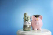 Piggy bank with graduation cap and 529 Plan coin jar -- college savings plan concept