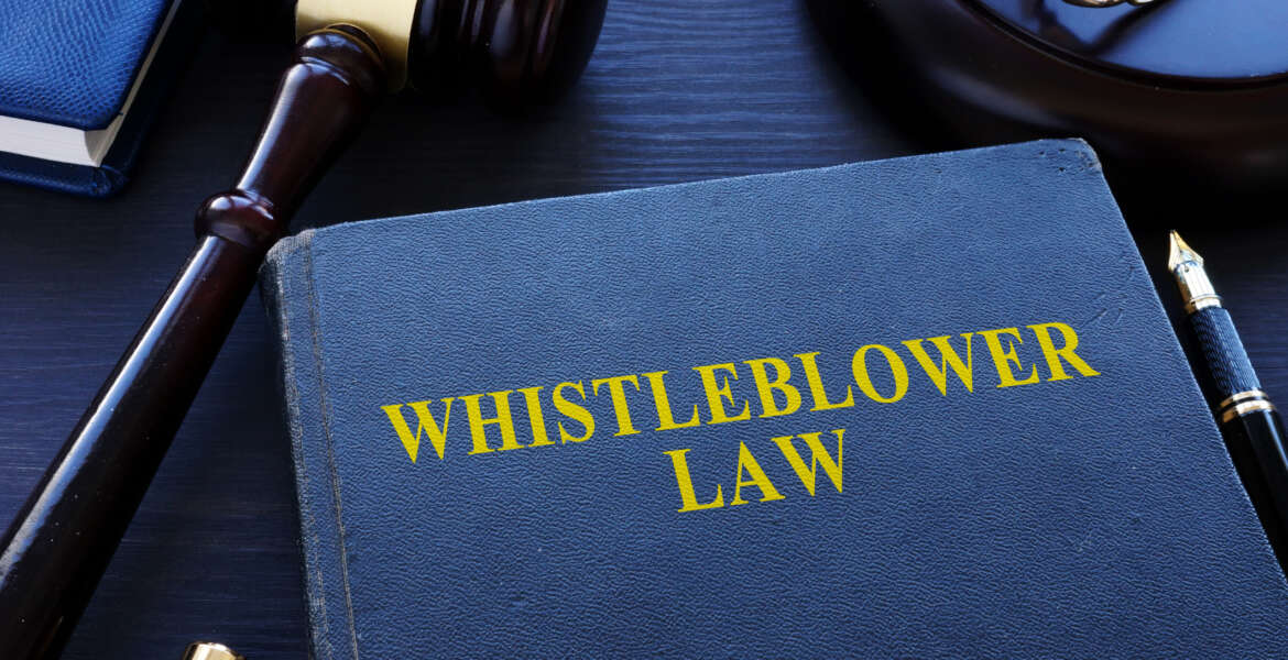 Whistleblower law book and gavel in a court.
