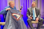 Tim Martin, a letter carrier in Buffalo, New York, shows off a cape his supervisors gave to him, after saving an elderly woman from a fire near her home. The National Association of Letter Carriers gave an award to Martin and other members for acts of heroism at a ceremony on March 27, 2024.