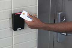 An employee swipes their personal identity verification (PIV) card