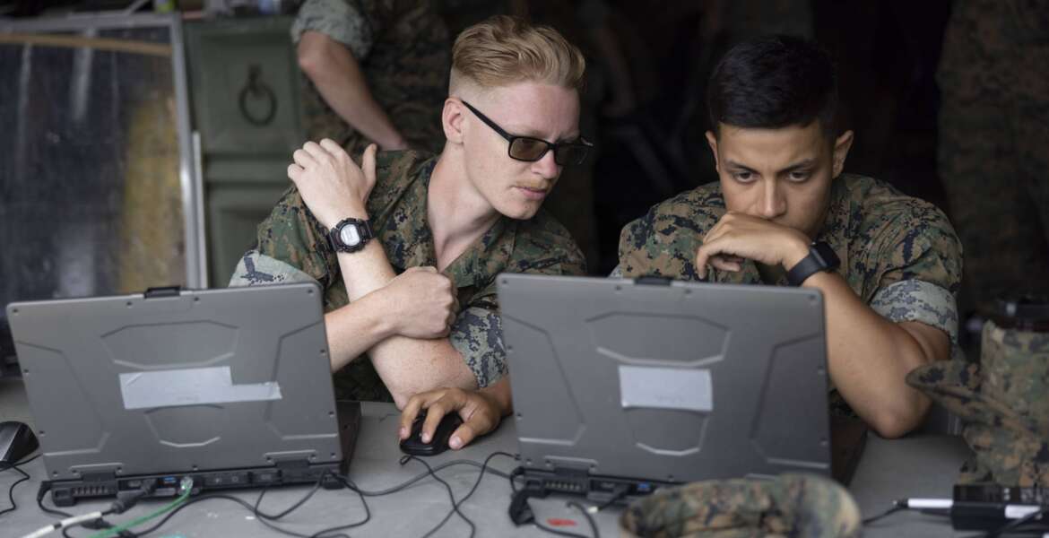 U.S. Marine Corps Cpl. Hunter Turk, left, and Pfc. Fernando Rey, fire support Marines with 2nd Air Naval Gunfire Liaison Company, deconflict a digital fire mission in support of exercise Burmese Chase aboard Marine Corps Base Camp Lejeune, North Carolina, April 27, 2023. The purpose of this training is to communicate with allied nations over the advanced field artillery tactical data system through the artillery systems cooperation agreement and variable message format. Burmese Chase is an annual U.S. led, multi-lateral exercise that includes training on integration of ground and air fires, infantry tactics and naval gunfire alongside NATO allies and partners. (U.S. Marine Corps photo by Lance Cpl. John Allen)