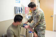 Spc. Luke Escamilla, a combat medic assigned to Headquarters Support Company, 4th Special Troops Battalion, 4th Division Sustainment Brigade, 4th Infantry Division, checks a patient’s blood pressure at the DiRaimondo Clinic May 1, 2024, at Fort Carson, Colorado. Combat medics serve in different positions, ranging from being in a line unit as a part of a combat force to working in a clinical setting under the supervision of a physician assistant. (U.S. Army photo by Pfc. Katie Freitas)