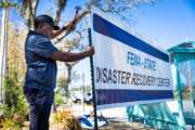 FEMA employee putting up a sign