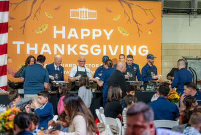 President Joe Biden serves meals to military families and guests at a “Friendsgiving” event at the U.S. Coast Guard Sector New York