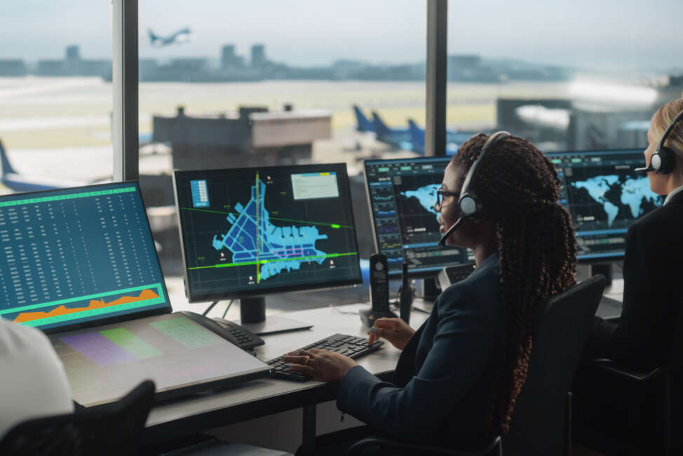 Female Air Traffic Controller with Headset Talk on a Call in Airport Tower