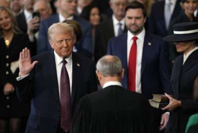 Donald Trump is sworn in as the 47th president of the United States by Chief Justice John Roberts as Melania Trump holds the Bible during the 60th Presidential Inauguration in the Rotunda of the U.S. Capitol in Washington, Monday, Jan. 20, 2025. 