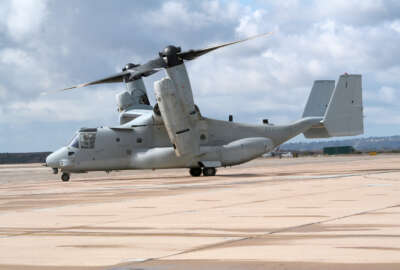 A military MV-22 Osprey preparing to takeoff on a cloudy day