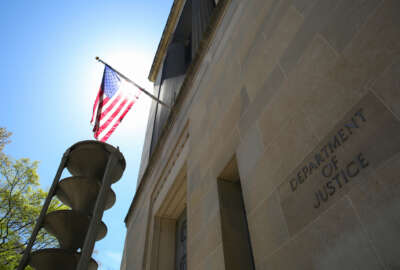 U.S. Department of Justice building and the American flag under the sun