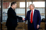 Elon Musk shakes hands with Donald Trump