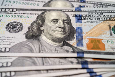 Close-up of inventor and U.S. founding father Benjamin Franklin's portrait on $100 bills.