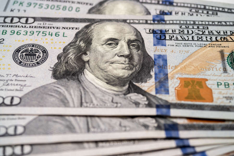 Close-up of inventor and U.S. founding father Benjamin Franklin's portrait on $100 bills.