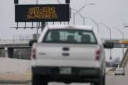 Vehicles pass a sign displaying Winter storm related operations Monday, Jan. 20, 2025, in Houston, ahead of predicted several inches of snow and possibly ice in Southeast Texas. (AP Photo/David J. Phillip)